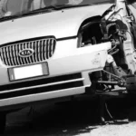 Used car buyer and mechanic inspecting a salvage title car in a dealership lot